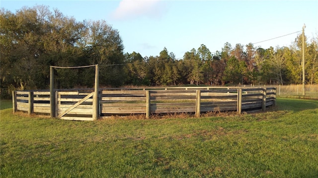 view of yard with an enclosed area and a rural view