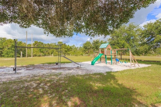 community jungle gym featuring a lawn