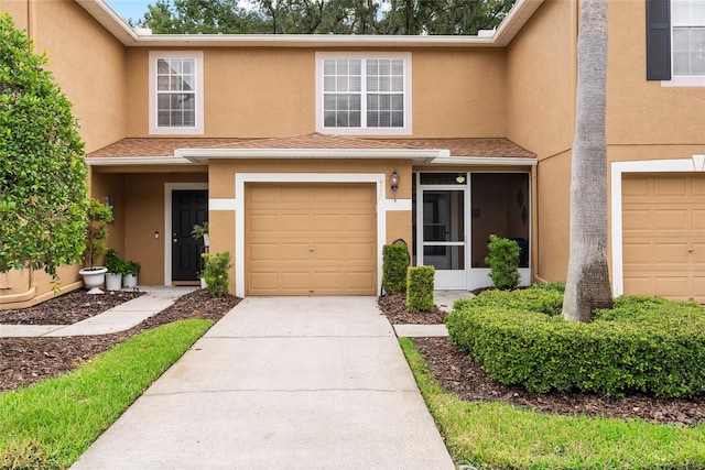 multi unit property featuring a garage