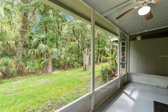 unfurnished sunroom with ceiling fan