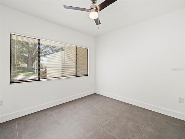 tiled empty room with ceiling fan