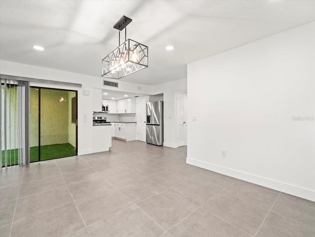 unfurnished living room with light tile patterned floors and a chandelier