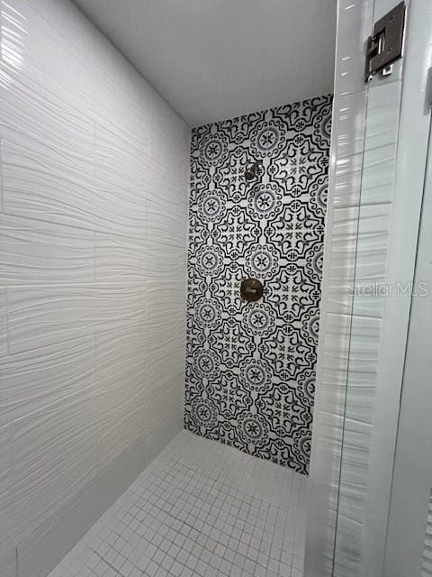 bathroom with a tile shower