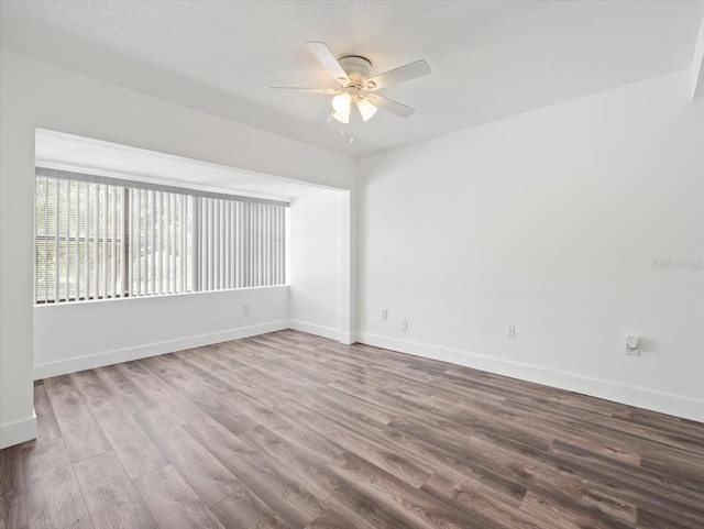 spare room with a textured ceiling, ceiling fan, and hardwood / wood-style floors