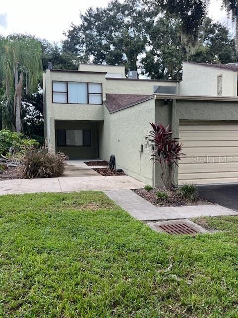 view of front of house featuring a garage and a front lawn