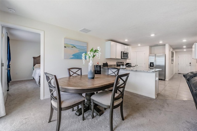 dining room featuring light colored carpet