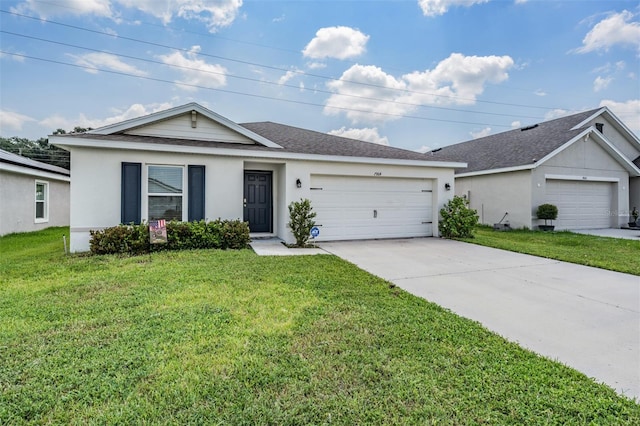 ranch-style house featuring a front lawn and a garage