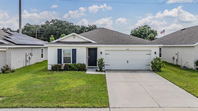 ranch-style house featuring a garage, solar panels, and a front yard