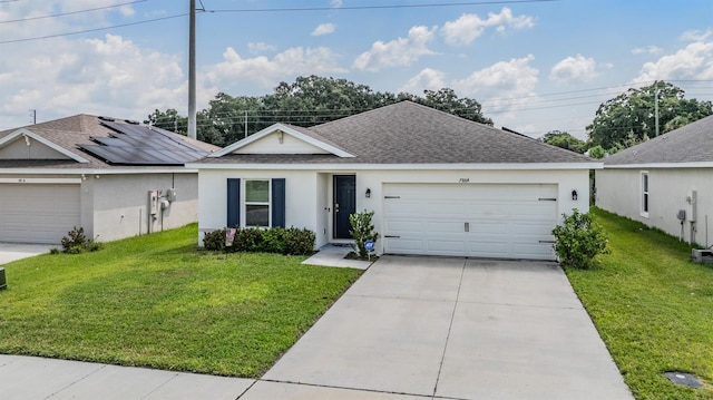 ranch-style home with a front lawn, solar panels, and a garage