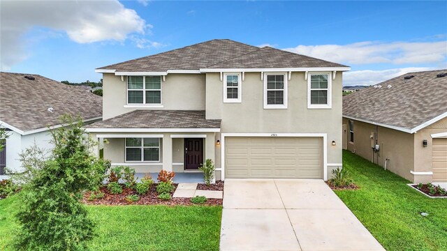 front of property featuring a front yard and a garage