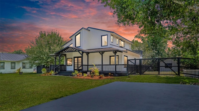 view of front of home with a porch and a yard