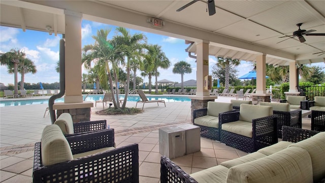 view of patio with outdoor lounge area, ceiling fan, and a community pool