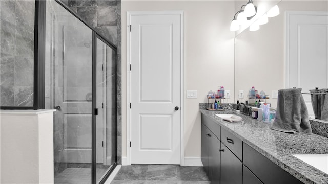 bathroom with tile patterned flooring, vanity, a shower with door, and a notable chandelier