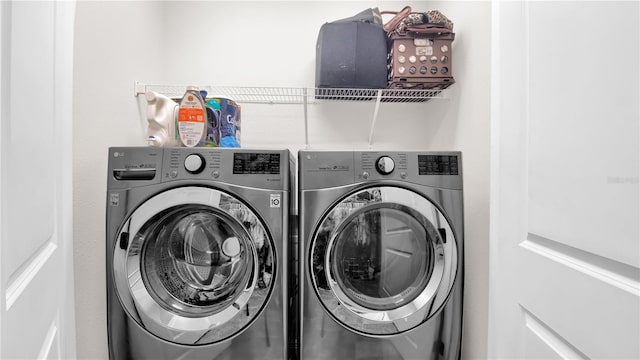 laundry room featuring washing machine and clothes dryer