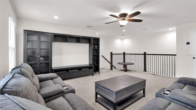 carpeted living room with ceiling fan