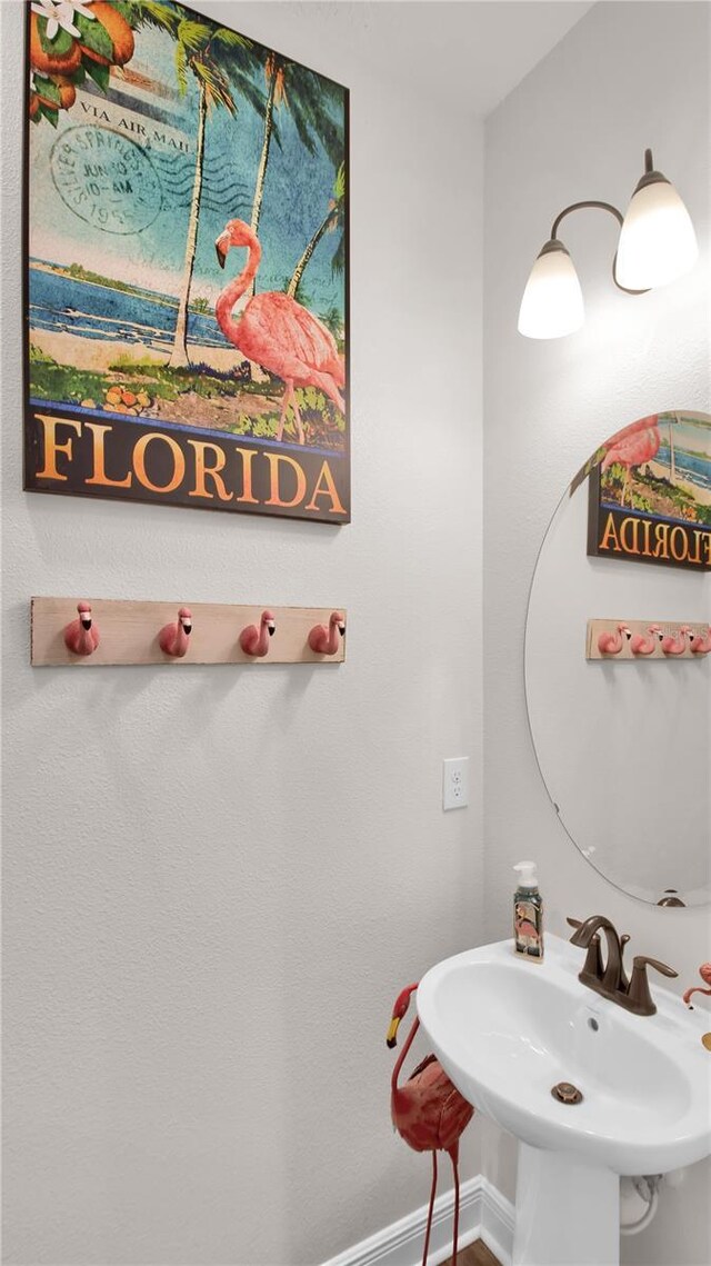 bathroom with baseboards and a sink