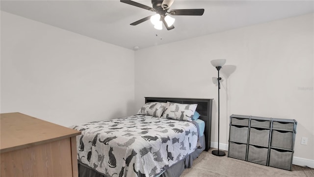 bedroom with ceiling fan, baseboards, and light colored carpet