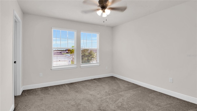 spare room featuring baseboards, a ceiling fan, and light colored carpet