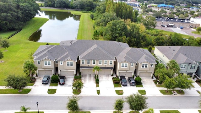 drone / aerial view featuring a water view and a residential view