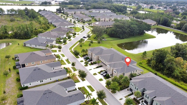 drone / aerial view with a water view and a residential view