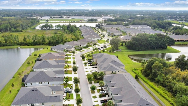 birds eye view of property featuring a water view and a residential view