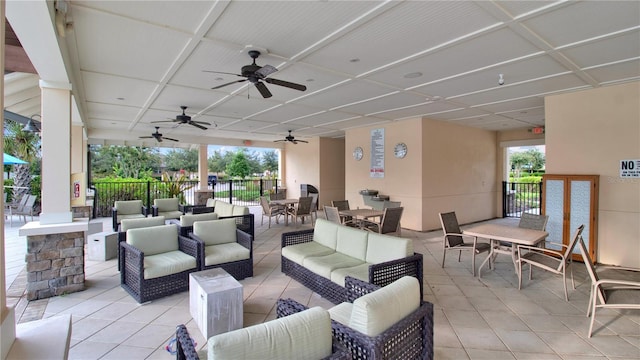 view of patio with outdoor dining space, outdoor lounge area, fence, and a ceiling fan