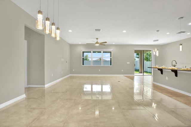 empty room featuring light tile patterned flooring and ceiling fan