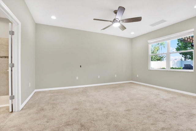 carpeted empty room featuring ceiling fan