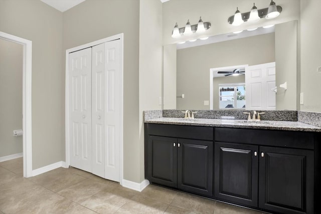 bathroom featuring dual vanity, ceiling fan, and tile patterned flooring