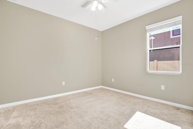 carpeted spare room featuring ceiling fan