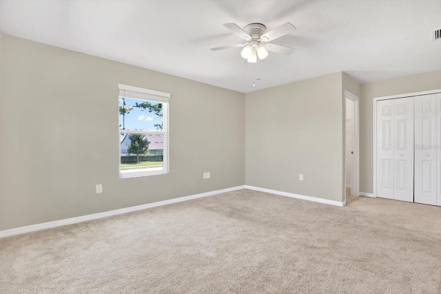 carpeted empty room featuring ceiling fan