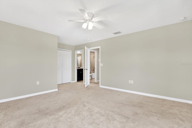 unfurnished bedroom with ceiling fan, light colored carpet, and a closet