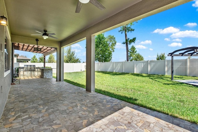 view of patio / terrace featuring ceiling fan, a pergola, and exterior kitchen