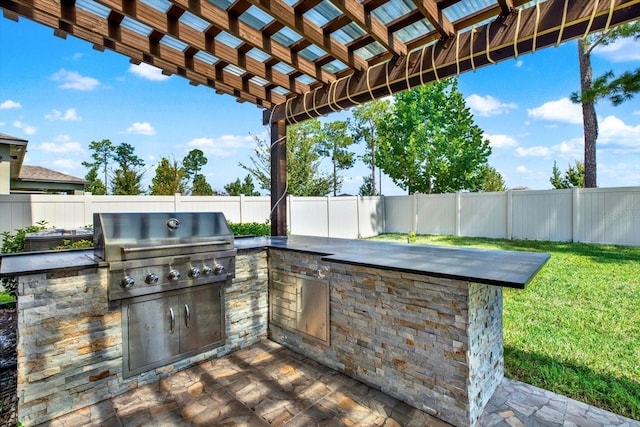 view of patio with a pergola, grilling area, and an outdoor kitchen