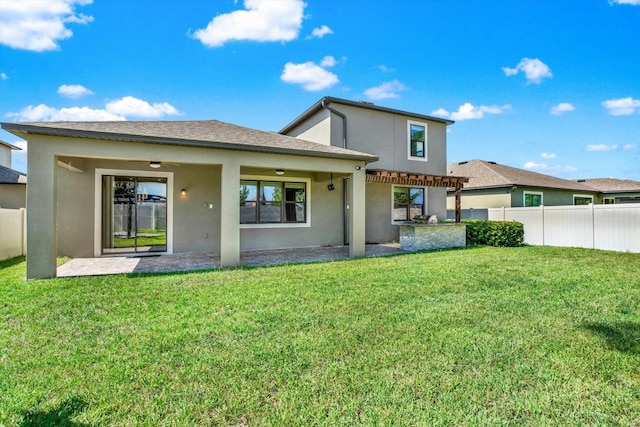 rear view of property with a pergola, a patio area, and a yard