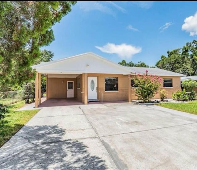 single story home featuring a carport