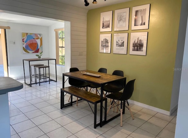 tiled dining room with rail lighting