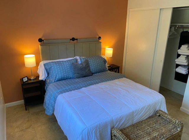 bedroom with a closet and light tile patterned floors