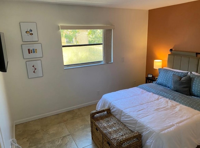 bedroom featuring light tile patterned flooring