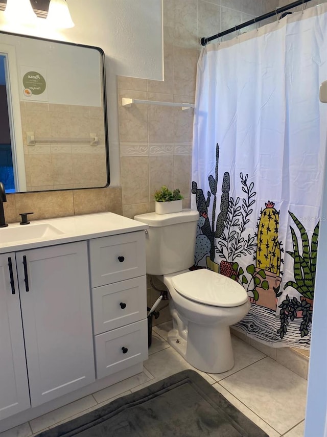 bathroom featuring tile patterned floors, vanity, and tile walls