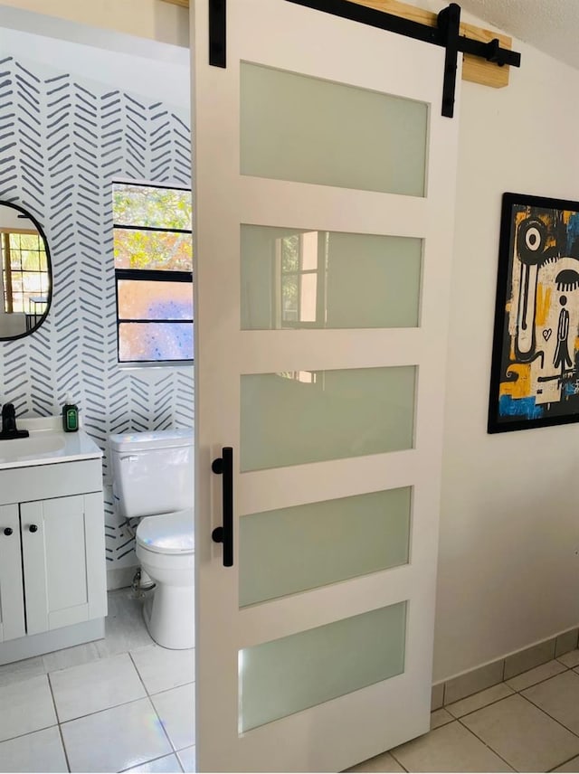 bathroom with tile patterned flooring, vanity, and toilet