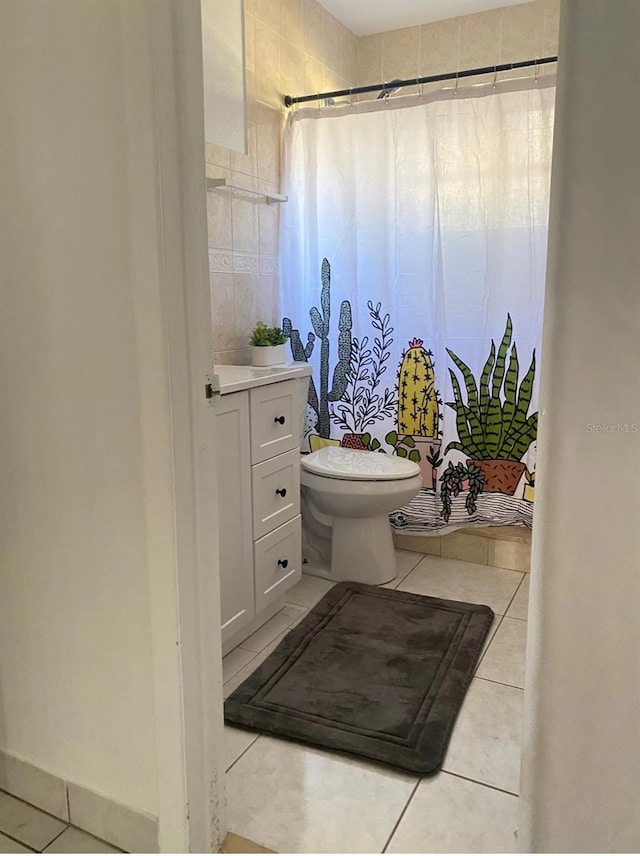 bathroom with tile patterned flooring, toilet, and vanity