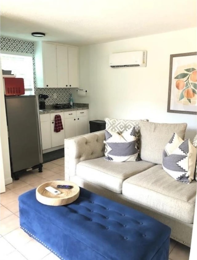 living room with a wall mounted AC and light tile patterned floors