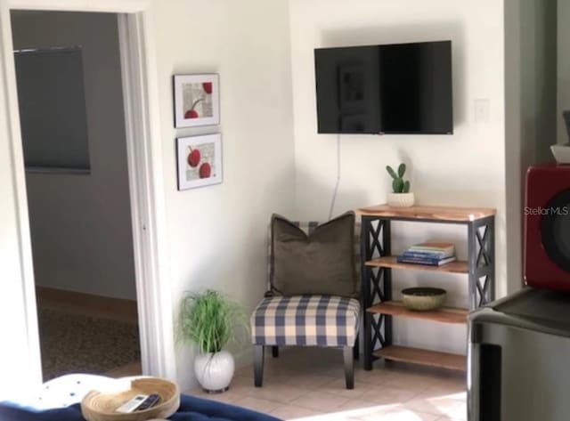 living area with tile patterned floors