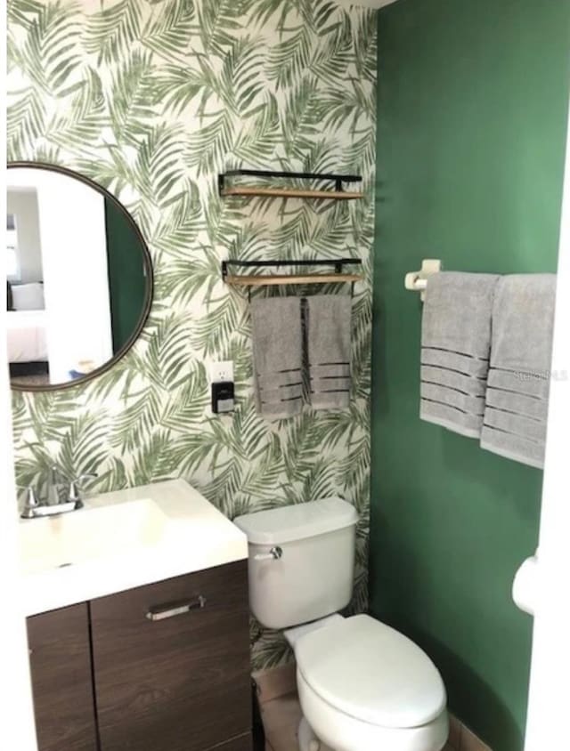 bathroom with toilet and vanity