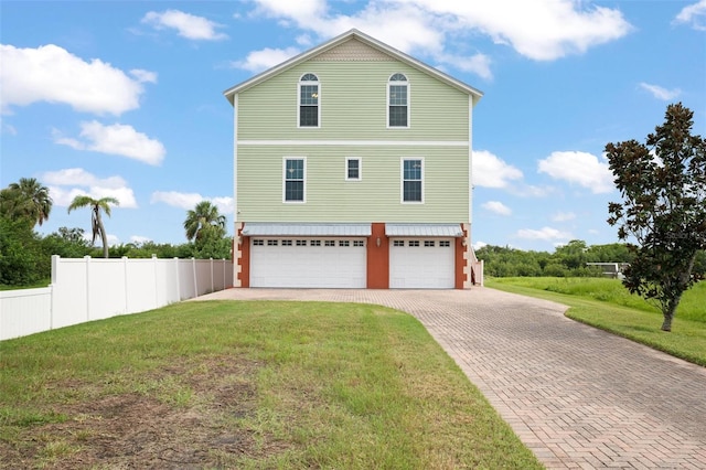 view of home's exterior featuring a garage and a yard