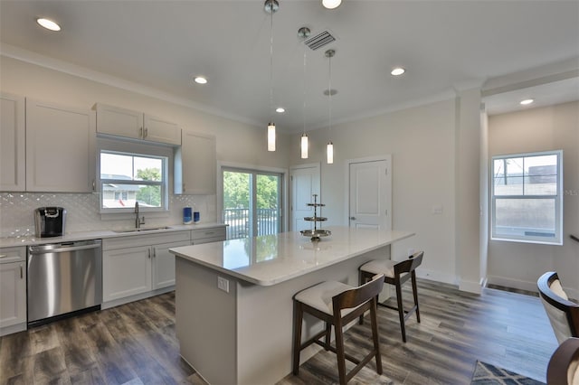 kitchen featuring sink, a center island, dark hardwood / wood-style flooring, and stainless steel dishwasher