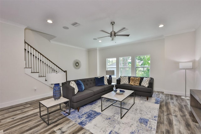 living room featuring hardwood / wood-style floors, ornamental molding, and ceiling fan