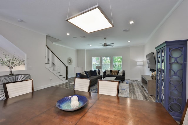 dining room with ceiling fan, crown molding, and hardwood / wood-style floors