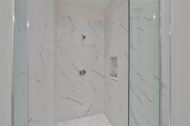 bathroom with a tile shower